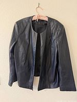 Front view of navy leather jacket showing overall style, zipper, seam details