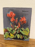 Front view of oil painting with red flowers