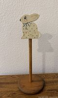 Front view of wooden base, dowel, hand-painted bunny topper