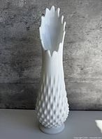 front view of white milk glass hobnail swung vase