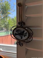 Front view of ornate oval mirror with bird design