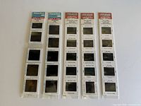 Four slide strips in original sleeves showing all slides