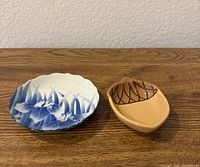 Both trinket dishes side by side on wood surface