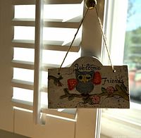 Full view of hanging plaque on window shutter