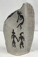 Front view showing petroglyph figures and stone-like texture