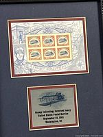 Close view of stamp sheet and plaque