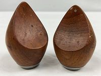 Front view of both teak shakers showing droplet shape and stainless bases