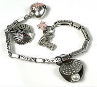 Full view of sterling silver bracelet showing links and all attached charms