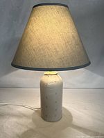 Full view of lamp with shade illuminated