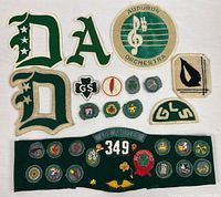 Overall lot showing merit badge sash, letter patches, orchestra patch and loose patches