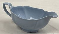 Left side view of light blue Greydawn gravy boat showing handle and contour