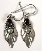 front view showing garnet stones and silver leaf motif