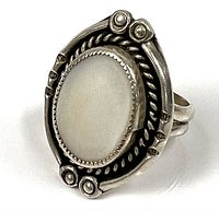 Front view of sterling silver ring with oval mother-of-pearl cabochon and decorative bezel