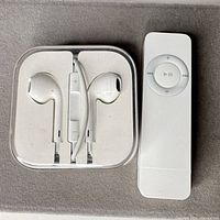 EarPods in case beside Apple remote front view