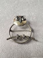 Front view of owl brooch showing design