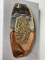 Front full view of belt buckle showing mixed metal design and overall condition