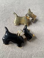 Front view of both Scottie dog brooches showing enamel, rhinestones and overall design
