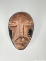 Front view showing facial details, color and surface wear