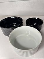 Three ceramic ramekins shown side by side displaying colors and ribbed exteriors