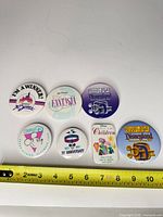 All seven Disney pinback buttons overview