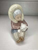 Front view of Lladró child with bear figurine