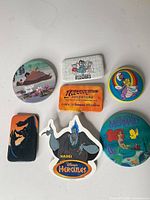 All seven Disney pinback buttons laid out for overall view