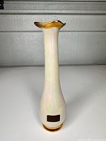 Full front view showing vase shape, glaze, and gold accents