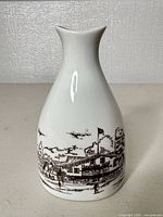 Front view shows scenic brown transfer print on white porcelain vase