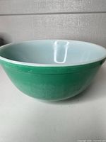 Full view of green exterior and white interior Pyrex bowl