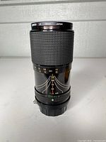 Front/side view showing lens barrel, focus and zoom markings, 58 mm filter ring