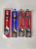 Front view of all four spoons in cases