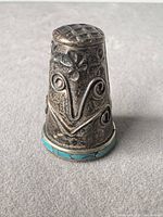 Front view showing turquoise band and ornate relief