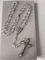 Entire rosary laid out showing length, beads, crucifix and center medal