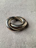 Front view of polished knot brooch