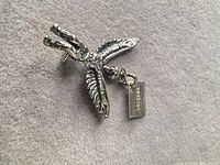 Pendant front showing Thunderbird design and ARIZONA tag