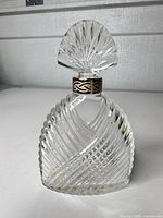 Front view of ribbed swirl glass perfume bottle with stopper inserted