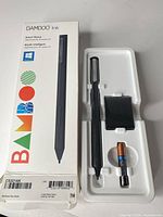 Retail box front and inner tray with stylus, battery, nib holder