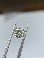 Diamond face-up view held by tweezers