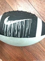 Side view showing black panel with white swoosh drip graphic