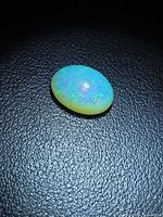 Top view of oval opal showing play-of-colour