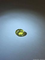 Oval faceted lemon citrine front view on white background