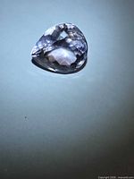 Oblique view of faceted pear-shape amethyst