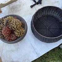 Wicker basket and bowl with pinecones
