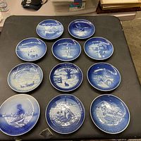 All eleven blue and white plates arranged on table