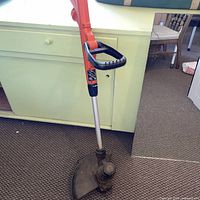 Full view of trimmer showing shaft, handle and head