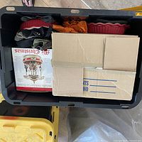 Overall view of tote with boxed carousel, ceramic dish, fabrics, and cardboard box