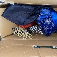 Top view of box showing blue snowflake fabric, red cloth and gold glitter scroll ornament