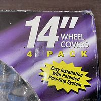 Front of box showing 14" wheel covers, 4 pack text