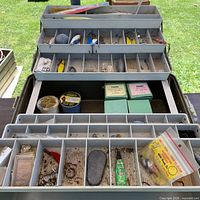Overall view of open tackle box showing trays and assorted contents