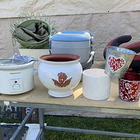 Mixed lot showing crockpot, ceramic and metal planters, cold therapy units
